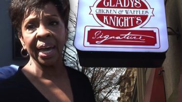 Gladys Knight in front her restaurant