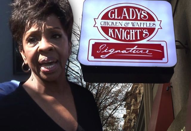 Gladys Knight in front her restaurant